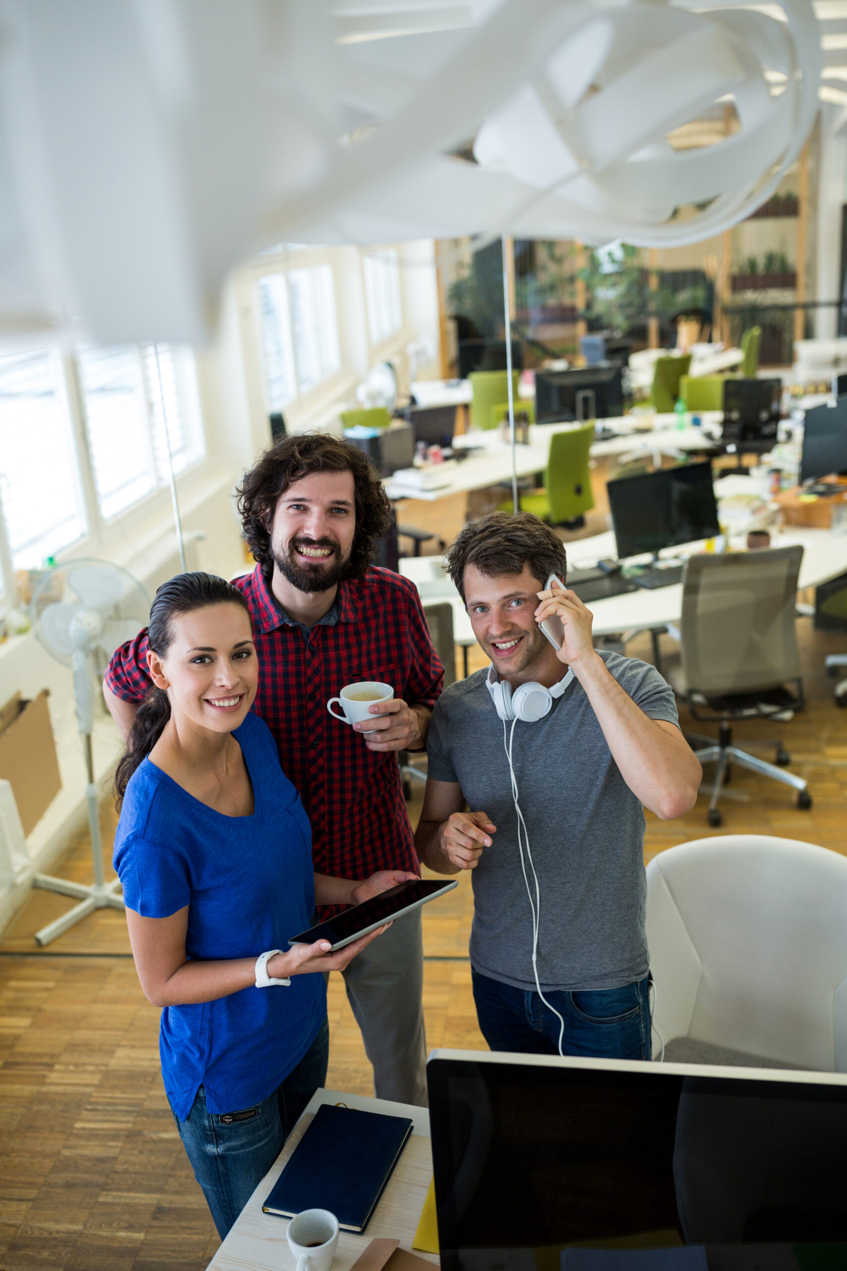 Group of graphics designers using digital tablet in office